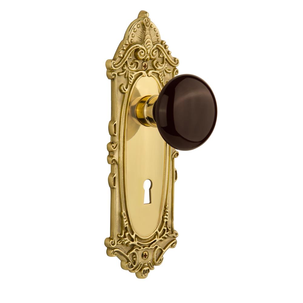 Nostalgic Warehouse VICBRN Single Dummy Knob Victorian Plate with Brown Porcelain Knob and Keyhole in Unlacquered Brass